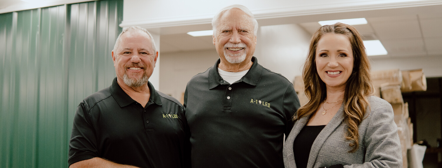 Smiling faces of A-1 LED’s executive team in Arkansas, including the founder, conveying the company’s friendly customer service ethos.